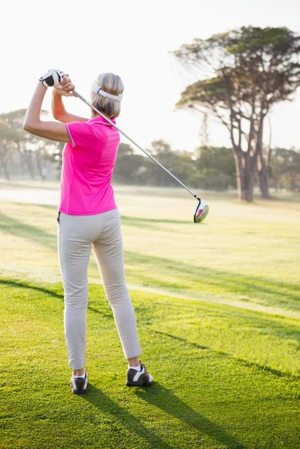 Rear view of sportswoman playing golf - Download Free Stock Photos Pikwizard.com
