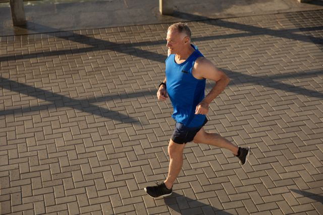 Senior male man running on the promenade - Download Free Stock Photos Pikwizard.com