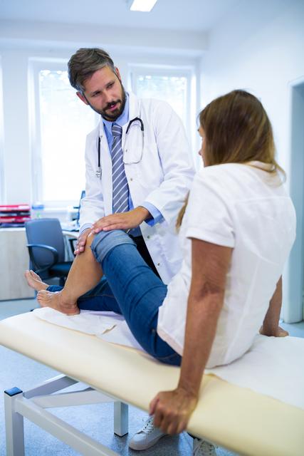 Male doctor examining patients knee - Download Free Stock Photos Pikwizard.com