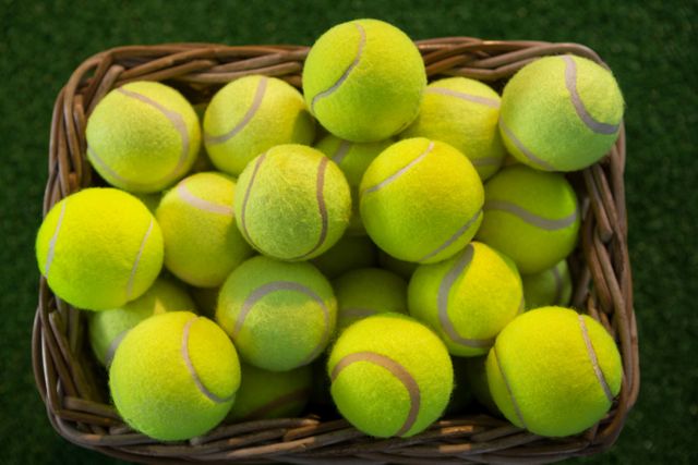 Directly above shot of tennis balls in wicker basket - Download Free Stock Photos Pikwizard.com