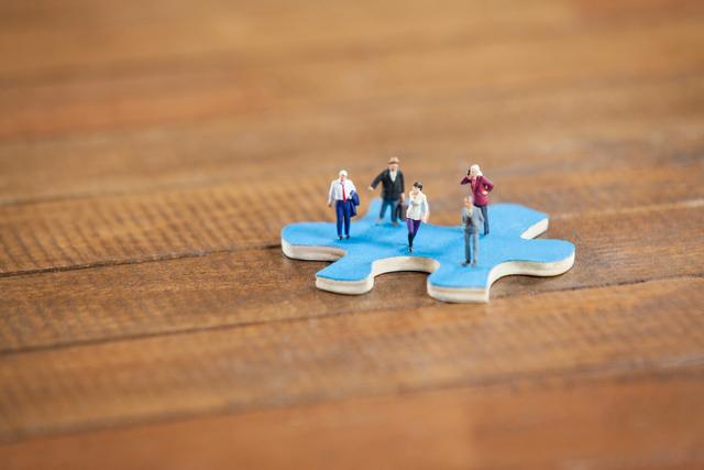Miniature people on a jigsaw puzzle - Download Free Stock Photos Pikwizard.com