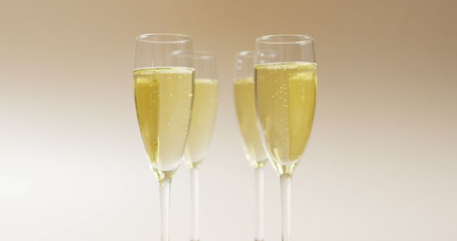 Image of champagne in glasses on beige background. alcohol, beverage, drinks, party and celebration concept.