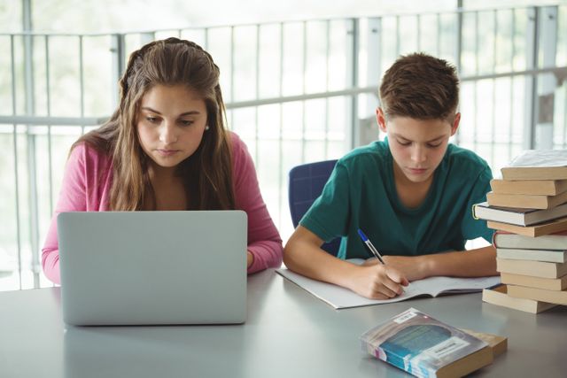 School kids doing homework in library - Download Free Stock Photos Pikwizard.com