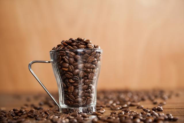 Transparent glass cup filled with coffee beans - Download Free Stock Photos Pikwizard.com