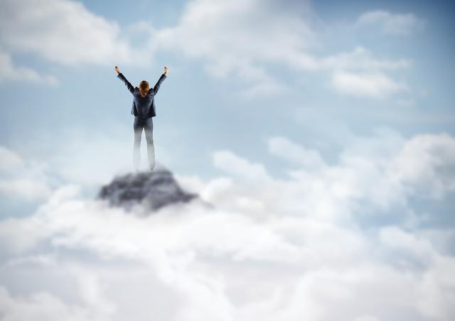 Business woman cheering on mountain peak in the clouds - Download Free Stock Photos Pikwizard.com