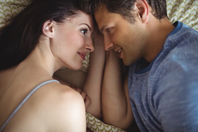 Romantic couple relaxing on bed - Download Free Stock Photos Pikwizard.com