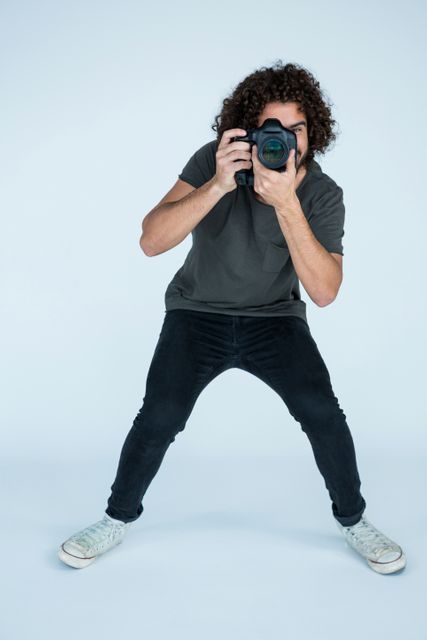 Photographer with digital camera in studio - Download Free Stock Photos Pikwizard.com