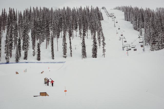 People skiing on snowy alps in ski resort during winter