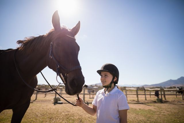 Smiling girl standing with the horse in the ranch - Download Free Stock Photos Pikwizard.com