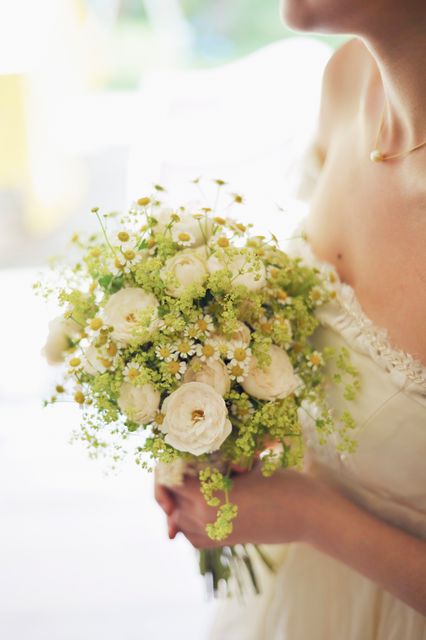 Woman in Bridal Gown Holding Bouquet of White Flowers - Download Free Stock Photos Pikwizard.com