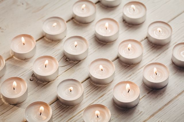 Candles burning on wooden table - Download Free Stock Photos Pikwizard.com