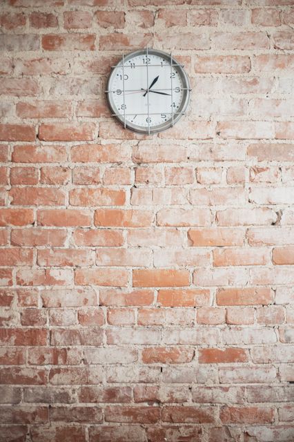 Low angle view of clock on brick wall - Download Free Stock Photos Pikwizard.com