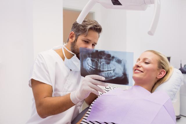Dentist showing x-ray to the patient - Download Free Stock Photos Pikwizard.com