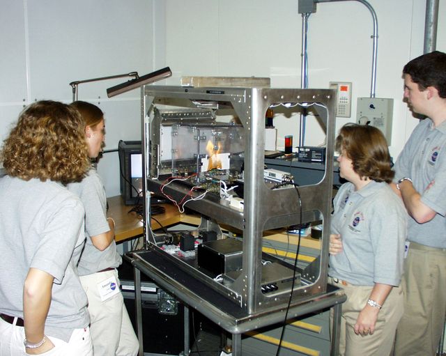 Students watch a test run on their experiment before the actual drop. They designed and built their apparatus to fit within a NASA-provided drop structure. This was part of the second Dropping in a Microgravity Environment (DIME) competition held April 23-25, 2002, at NASA's Glenn Research Center. Competitors included two teams from Sycamore High School, Cincinnati, OH, and one each from Bay High School, Bay Village, OH, and COSI Academy, Columbus, OH. DIME is part of NASA's education and outreach activities. Details are on line at http://microgravity.grc.nasa.gov/DIME_2002.html.