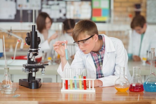 Attentive schoolboy doing a chemical experiment in laboratory - Download Free Stock Photos Pikwizard.com