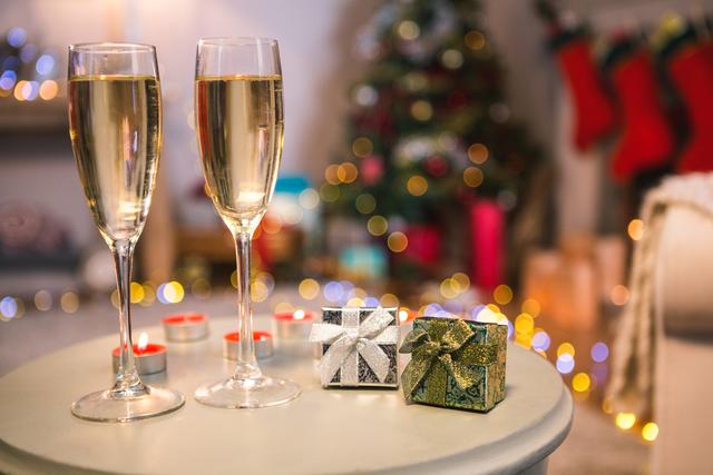 Champagne glasses and gifts box on table - Download Free Stock Photos Pikwizard.com