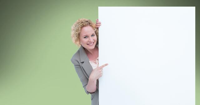 Businesswoman pointing at blank bill board - Download Free Stock Photos Pikwizard.com