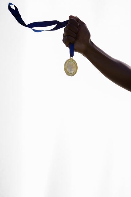 Hand of athlete holding gold medal - Download Free Stock Photos Pikwizard.com