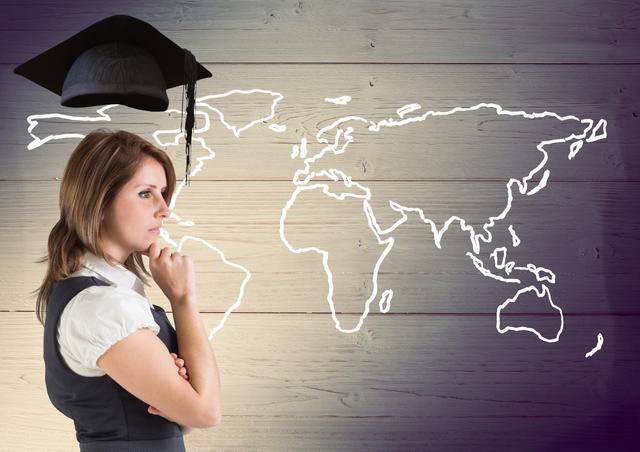 Thoughtful businesswoman with graduation cap against world map in wooden background - Download Free Stock Photos Pikwizard.com