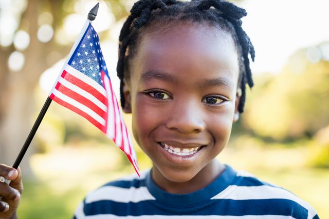 Happy child holding an usa flag - Download Free Stock Photos Pikwizard.com