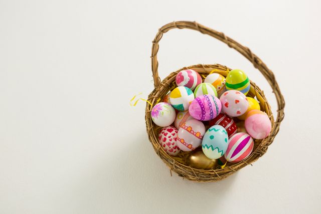 Basket with painted Easter eggs on white background - Download Free Stock Photos Pikwizard.com