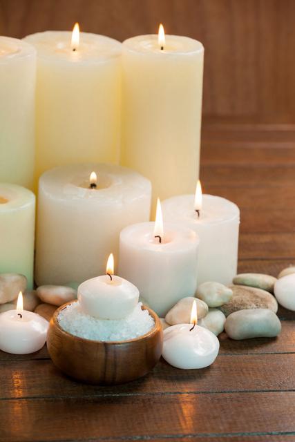 Candles with massage oil bottles and sea salt in wooden bowl - Download Free Stock Photos Pikwizard.com