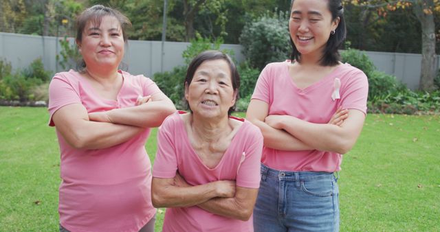 Portrait of smiling asian adult granddaughter, mother and grandmother standing in garden smiling. retirement lifestyle, happy family spending quality time at home together.