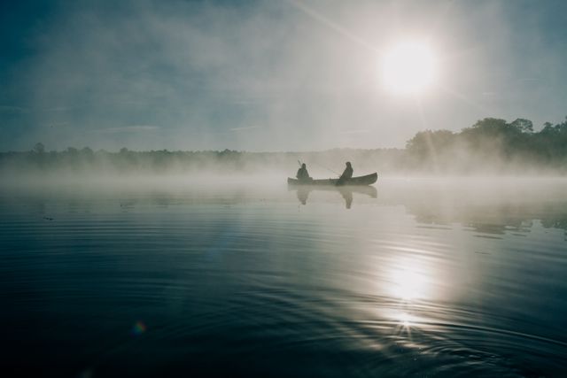 2 Men on Boat at Calm Foggy Lake during Daytime - Download Free Stock Photos Pikwizard.com