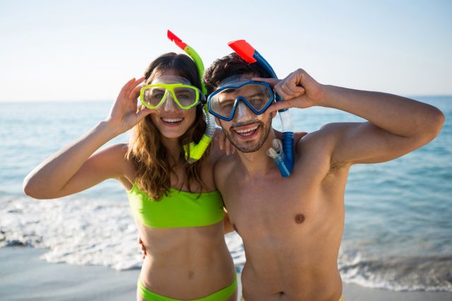 Portrait of happy young couple wearing scuba masks at beach - Download Free Stock Photos Pikwizard.com