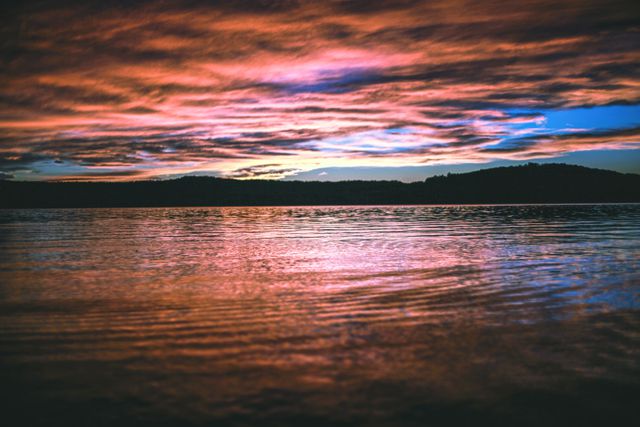 a sunset over a lake - Download Free Stock Photos Pikwizard.com
