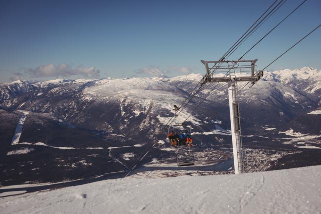 Low angle view of skiers travelling in ski lift at ski resort