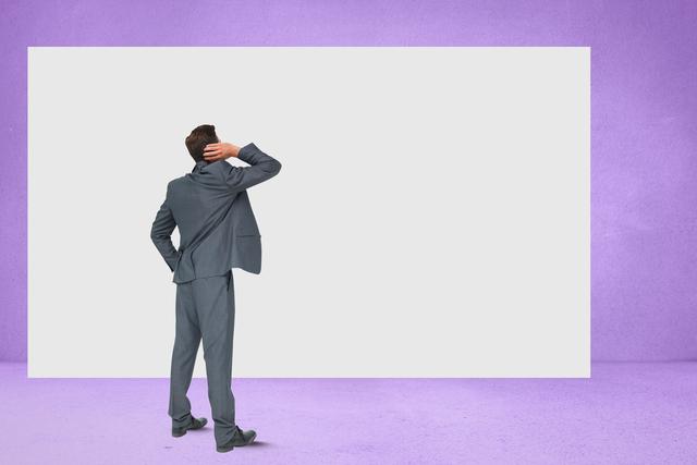 Rear view of confused businessman looking at blank billboard against purple wall - Download Free Stock Photos Pikwizard.com