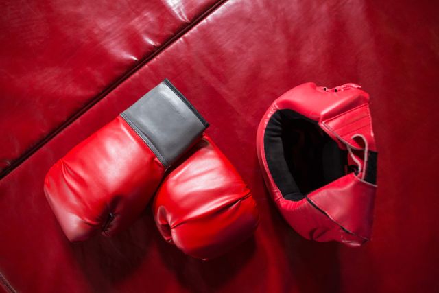 Pair of red boxing gloves and headgear - Download Free Stock Photos Pikwizard.com