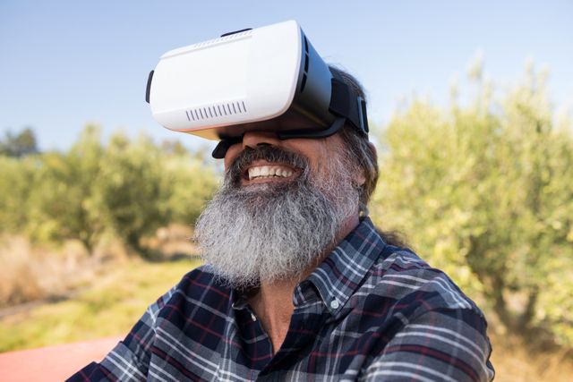 Happy man using virtual reality headset in olive farm - Download Free Stock Photos Pikwizard.com