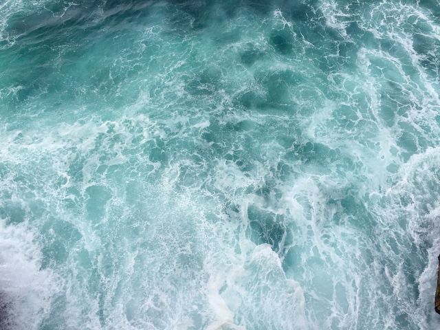 a wave crashing into the ocean - Download Free Stock Photos Pikwizard.com