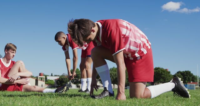 Team of diverse boy rugby players practicing on rugby field with copy ...