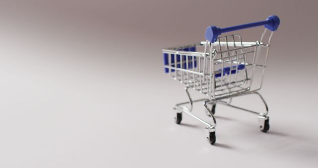 Empty blue shopping trolley on seamless grey background - Download Free Stock Photos Pikwizard.com