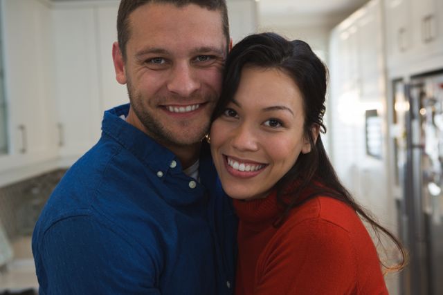 Portrait of couple embracing each other at home