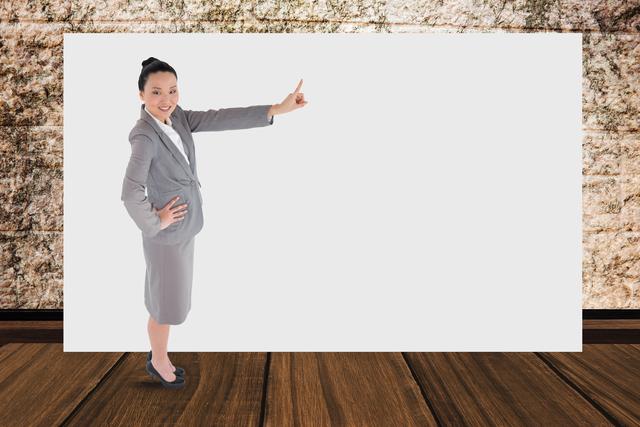 Businesswoman gesturing on blank billboard while standing in office - Download Free Stock Photos Pikwizard.com