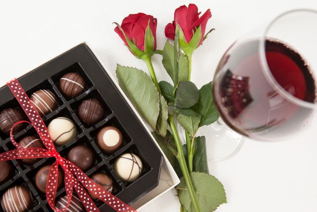 Bunch of roses, champagne bottle, wine glass and assorted chocolate box - Download Free Stock Photos Pikwizard.com