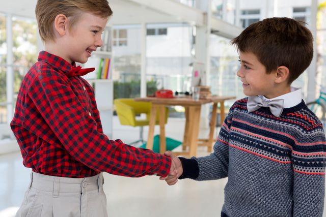 Kids as business executives shaking hands - Download Free Stock Photos Pikwizard.com