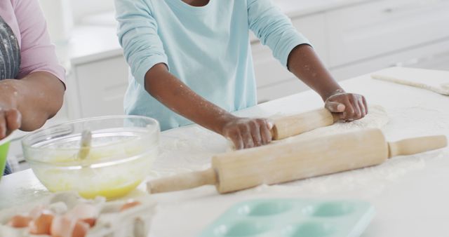 Happy african american grandmother and granddaughter baking in kitchen, high fiving, copy space. Family, health, togetherness and domestic life.