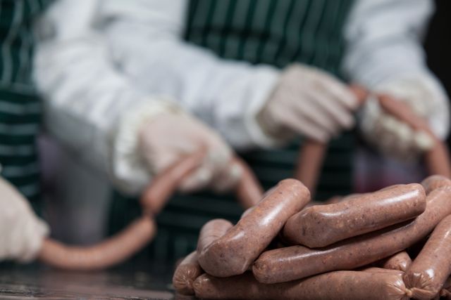 Butchers processing sausages - Download Free Stock Photos Pikwizard.com