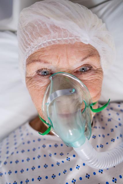 Senior patient wearing oxygen mask lying on hospital bed - Download Free Stock Photos Pikwizard.com