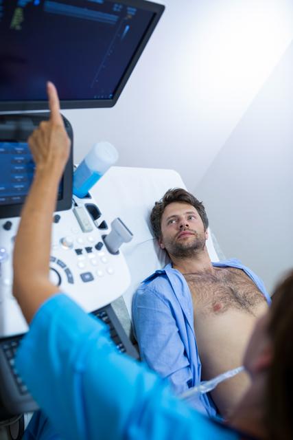 Man getting ultrasound of a abdomen from doctor in hospital