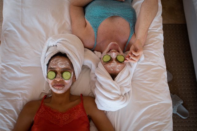 Two diverse female friends relaxing together with face masks - Download Free Stock Photos Pikwizard.com