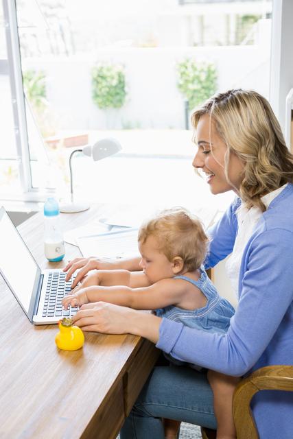 Mother and baby girl using laptop - Download Free Stock Photos Pikwizard.com