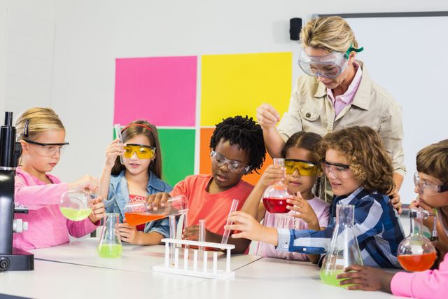 Teacher assisting kids in laboratory - Download Free Stock Photos Pikwizard.com