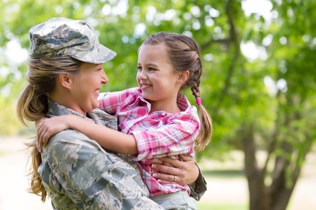 Happy female soldier with her daughter in park - Download Free Stock Photos Pikwizard.com