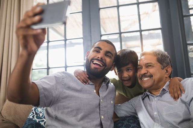 Smiling multi-generation family making face while taking selfie at home - Download Free Stock Photos Pikwizard.com